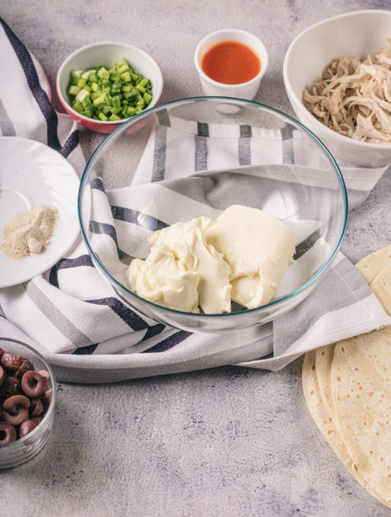 A picture of ingredients needed to make buffalo chicken pinwheel sandwiches.