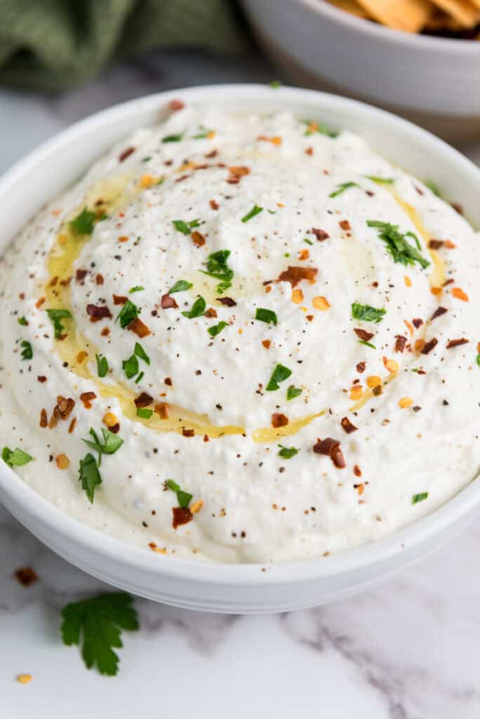 A close up picture of a bowl of amazing whipped feta dip.
