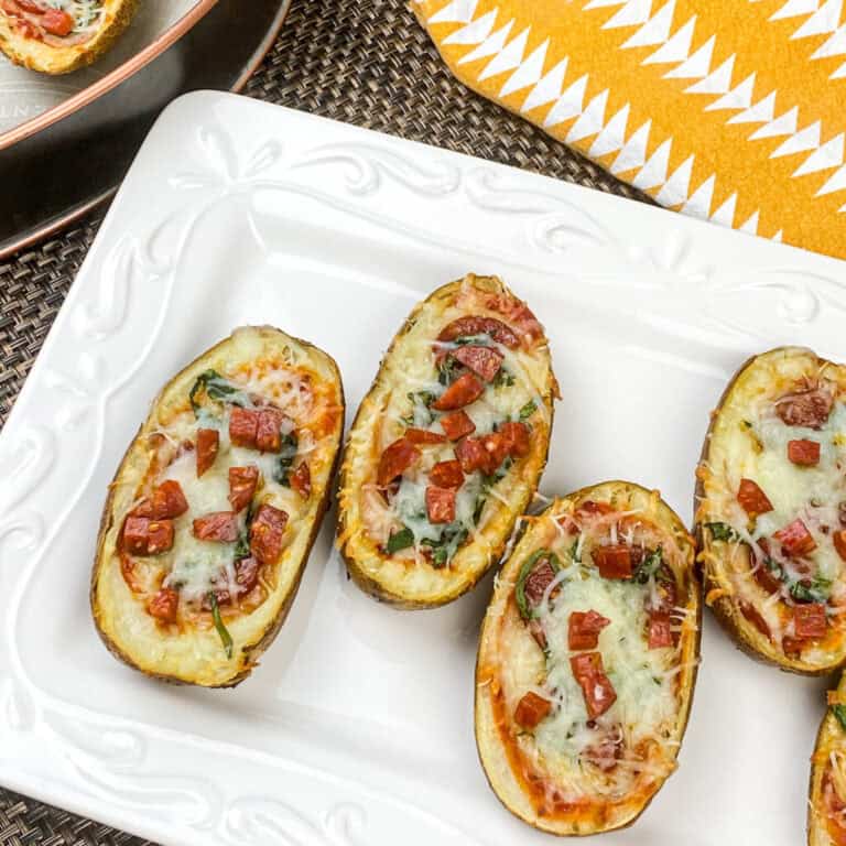 A picture of a row of pizza stuffed baked potato skins.