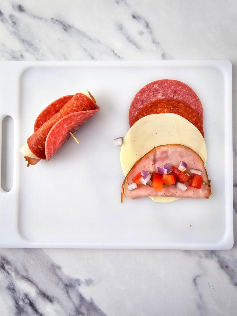 A picture of the roll of meats and cheese secured with a toothpick.