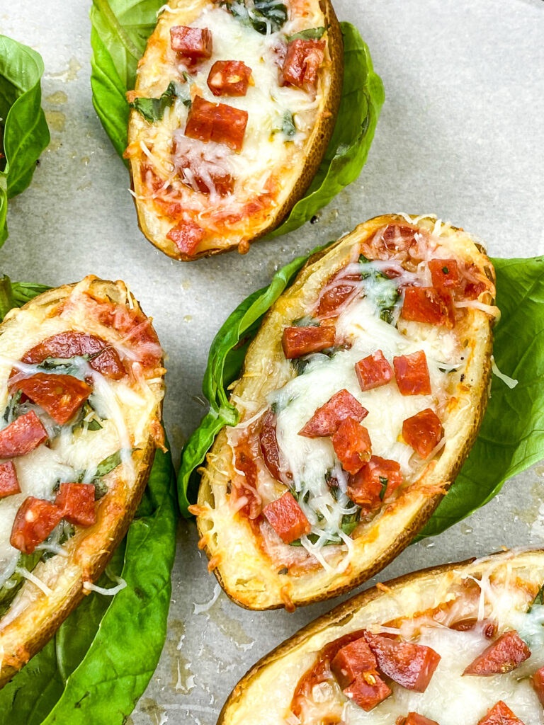 A close up picture of pizza stuffed baked potato skins. roundup