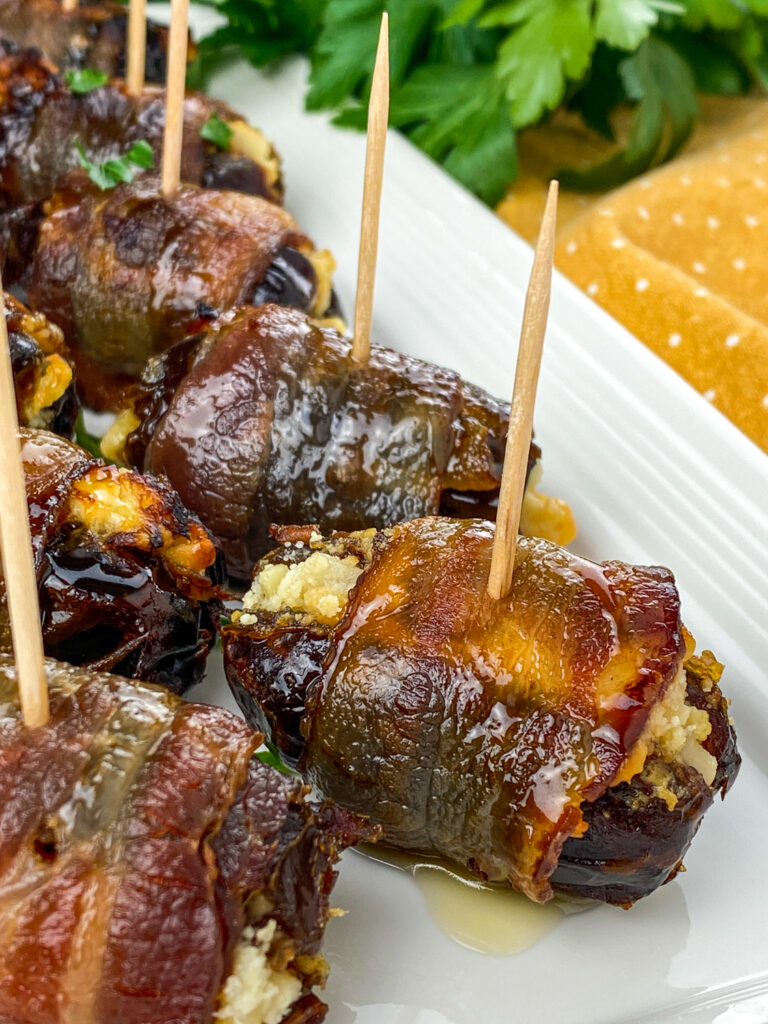 A close up picure of bacon wrapped dates.