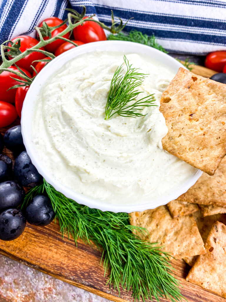 A picture of whipped feta dip with some placed on a cracker. roundup