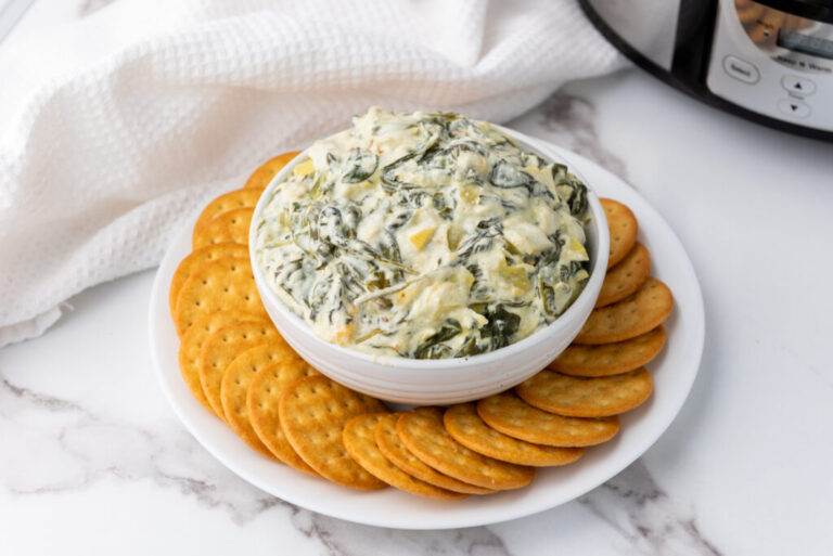 A picture of a bowl of spinach artichoke dip.