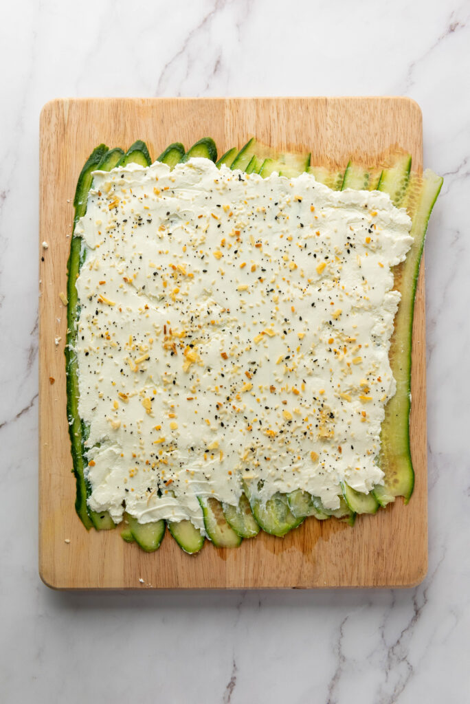 everything bagel seasoning spread out over cucumbers and cream cheese