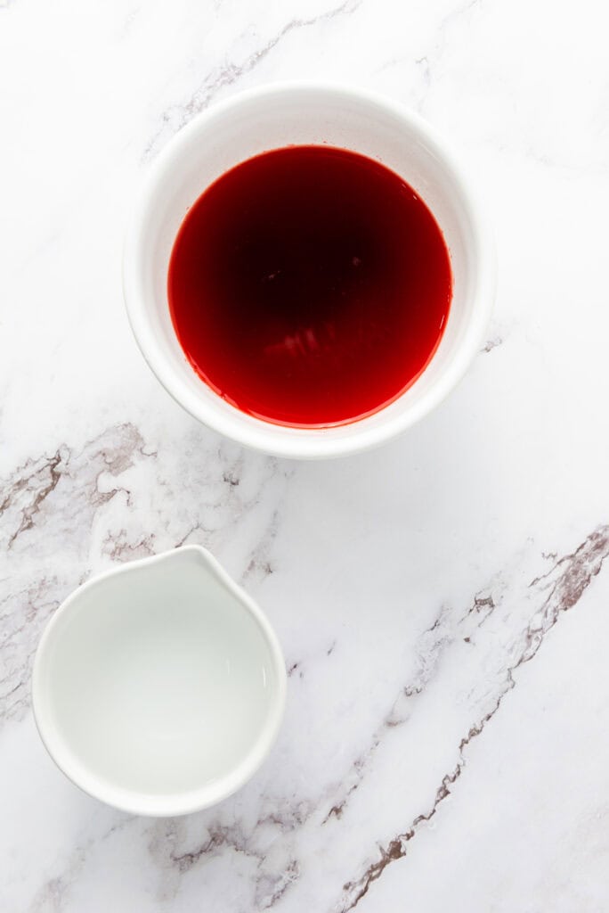 red jello dissolved in a cup of water