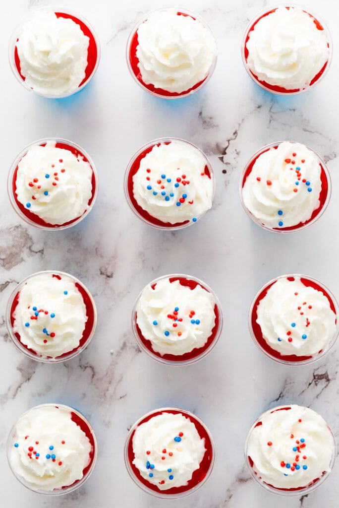 sprinkles and whipped cream on top of jello shots