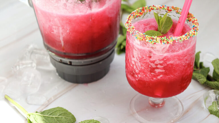 watermelon slushie next to the blender it was made in