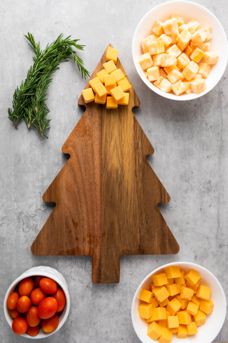 A row of cheese added to the top of the christmas tree charcuterie board