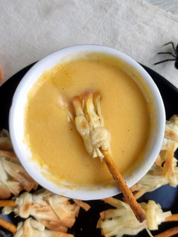 Witch's broom dipped in cheese sauce.