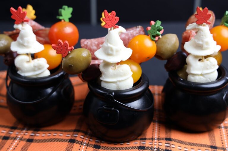 black cauldrons with trendy halloween figureines inside