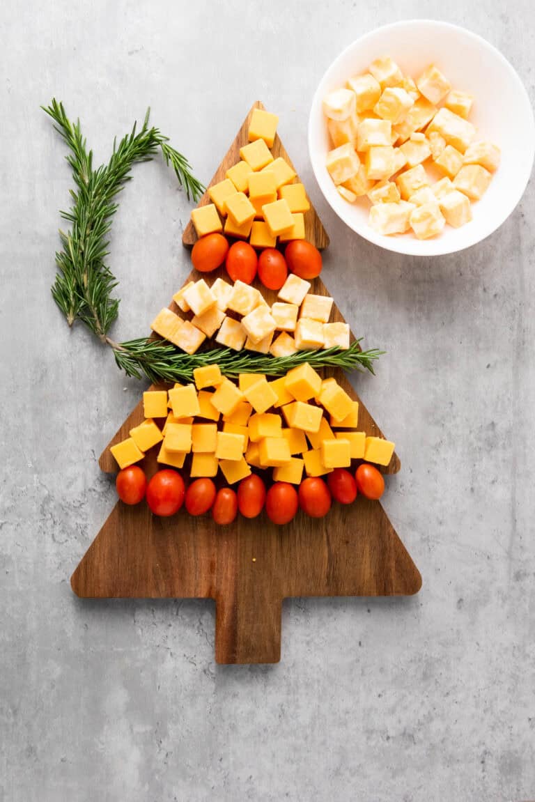 patterened cheese, tomatoes and rosemary stripes to create a cheese xmax charcuterie platter