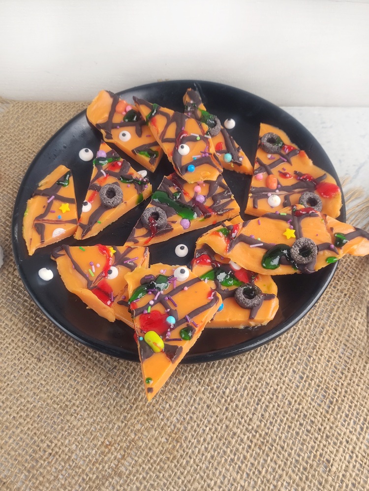 white chocolate bark pieces on a black plate for halloween