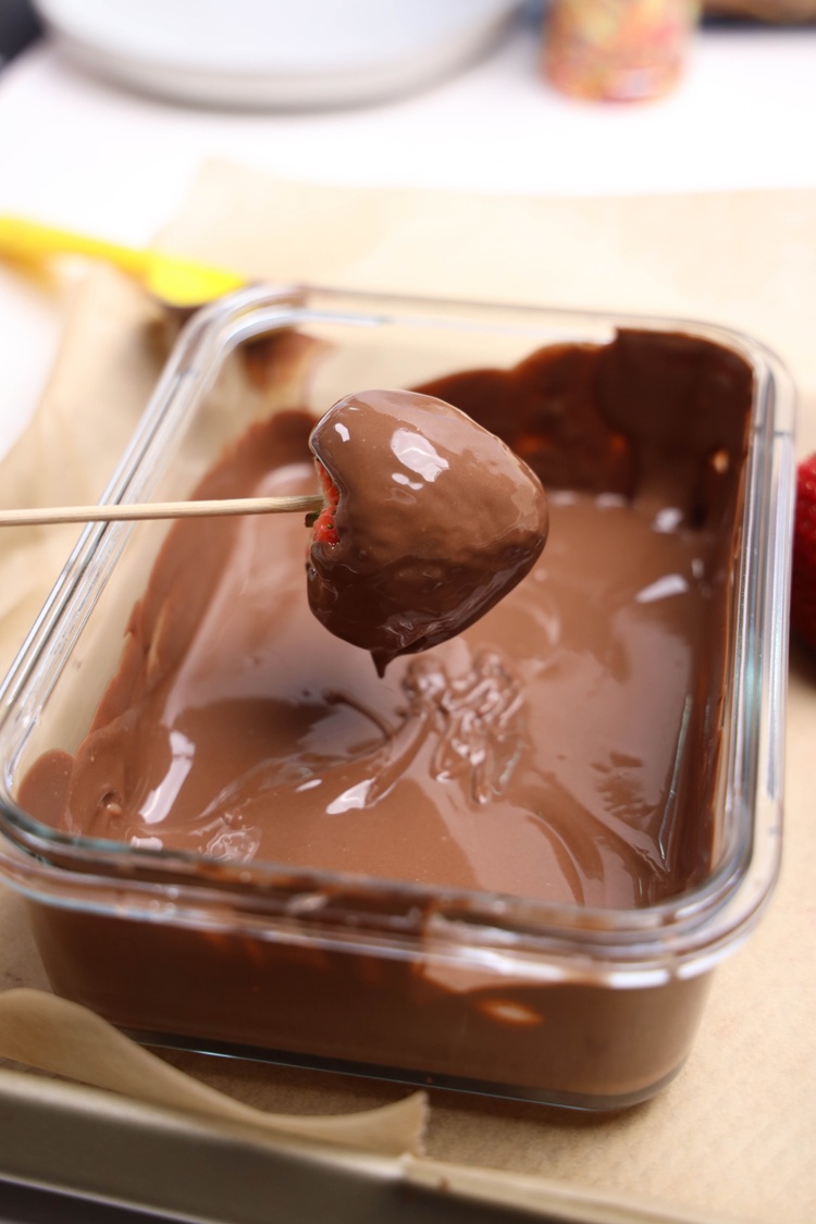 melted chocolate with strawberry dipped inside