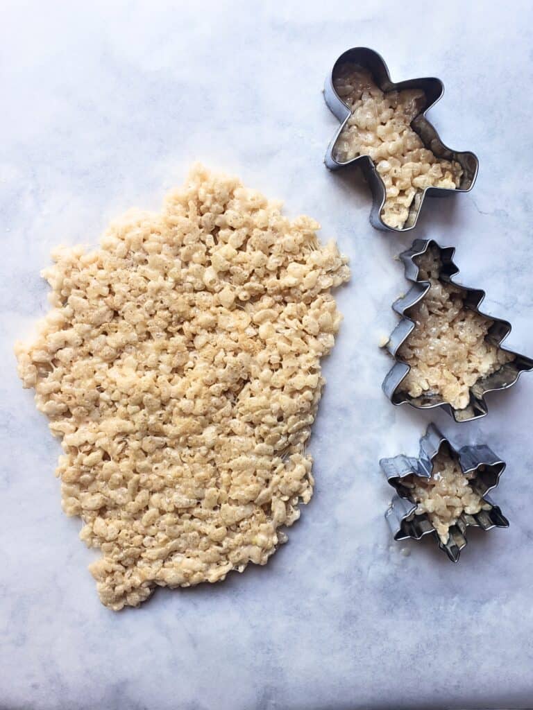 cutouts of rice krispies treats next to a block of more treats material