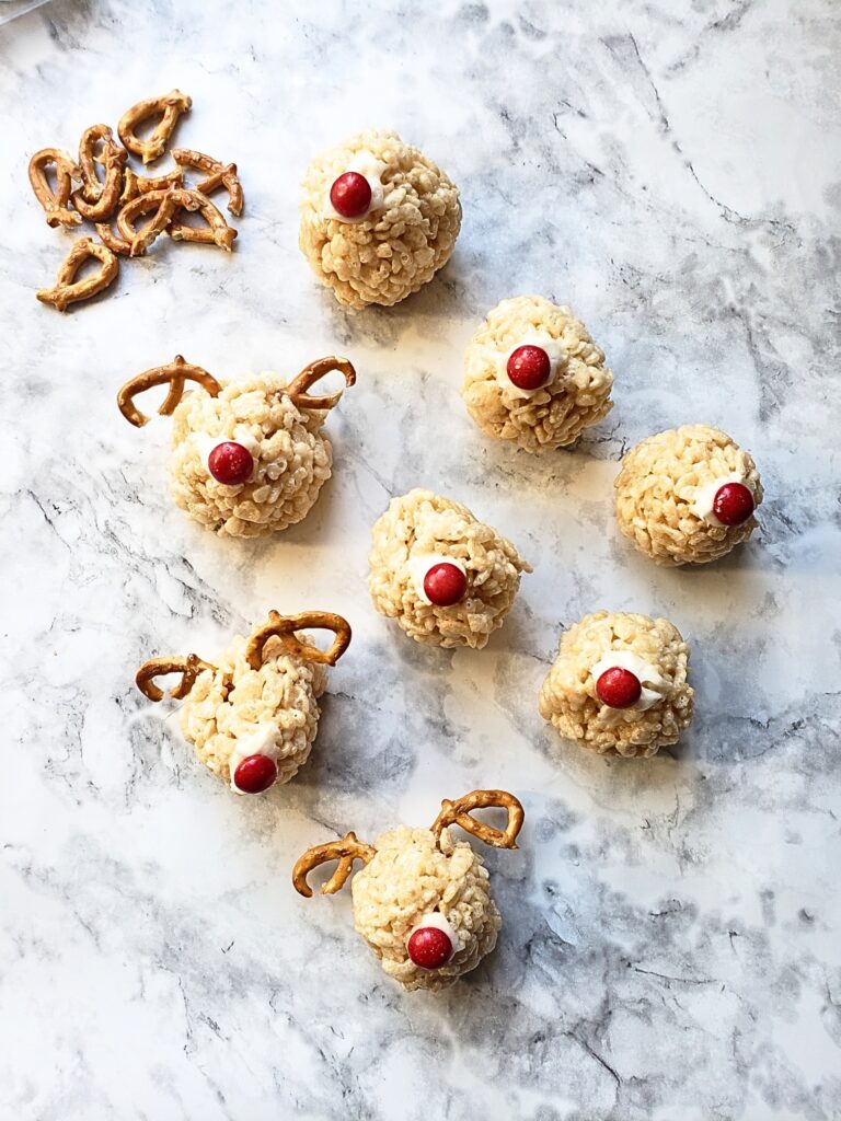 pretzels broken into halves and placed into sides of krispy balls to form antlers