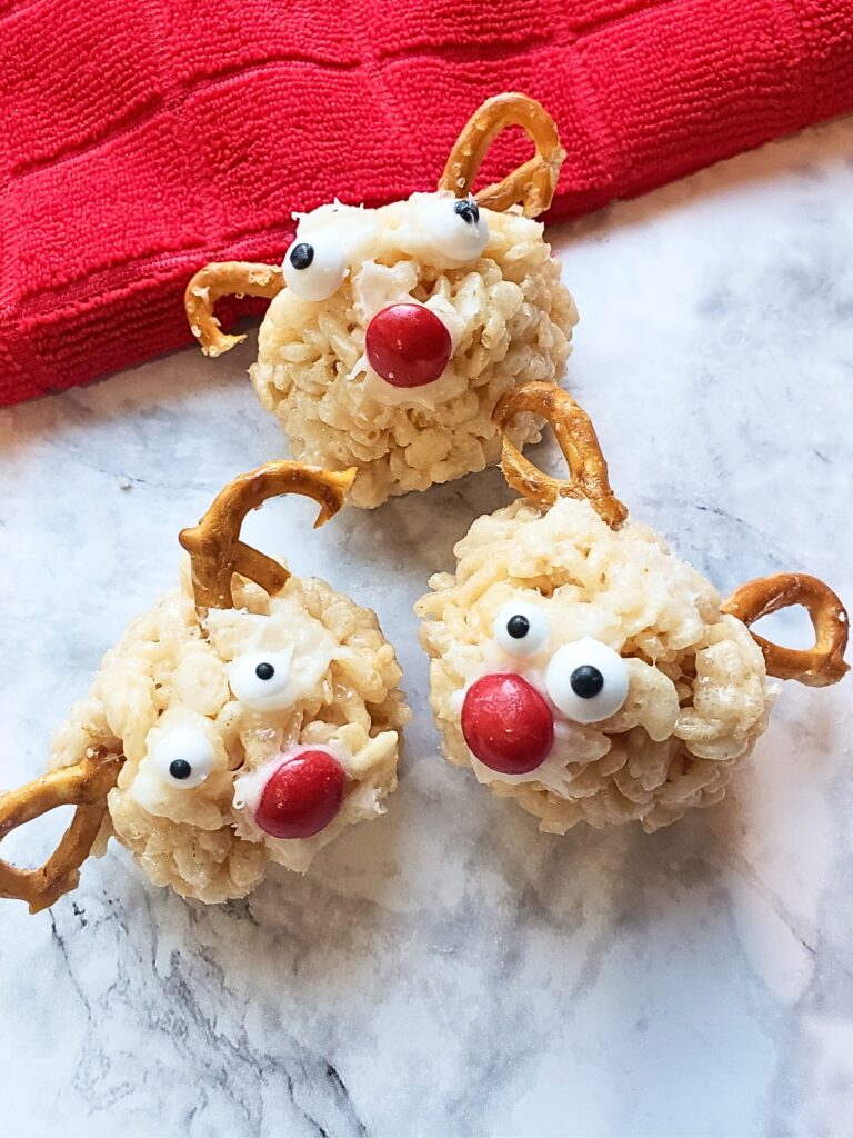 reindeer rice krispies on a marble countertop with a red towel behind 