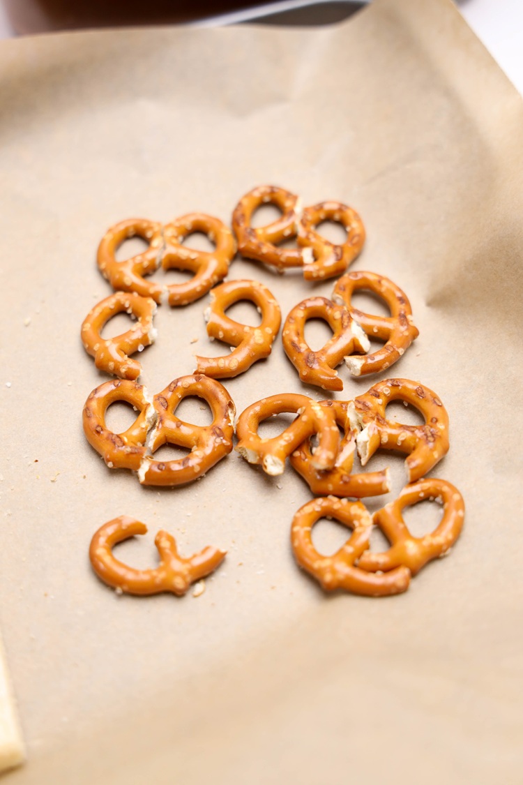pretzels broken in half on parchment paper