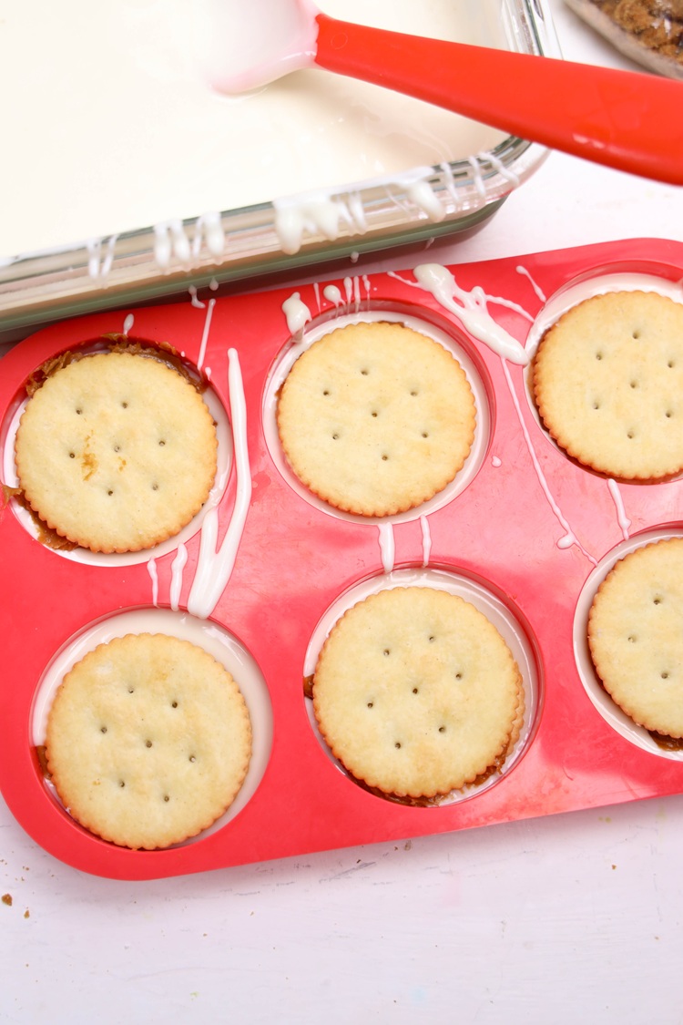 Spread Biscoff cookie butter between two Ritz crackers and place the sandwich into the mold. Repeat for all molds
