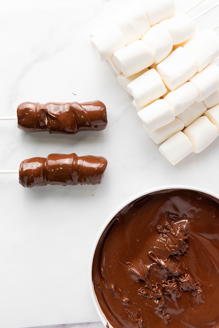 chocolate chips melted until smooth next to marshmallows