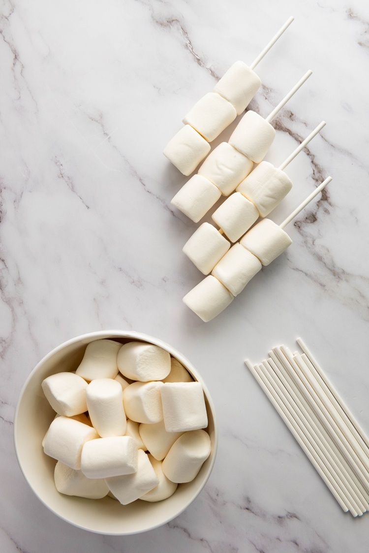 three marshmallows threaded through a stick