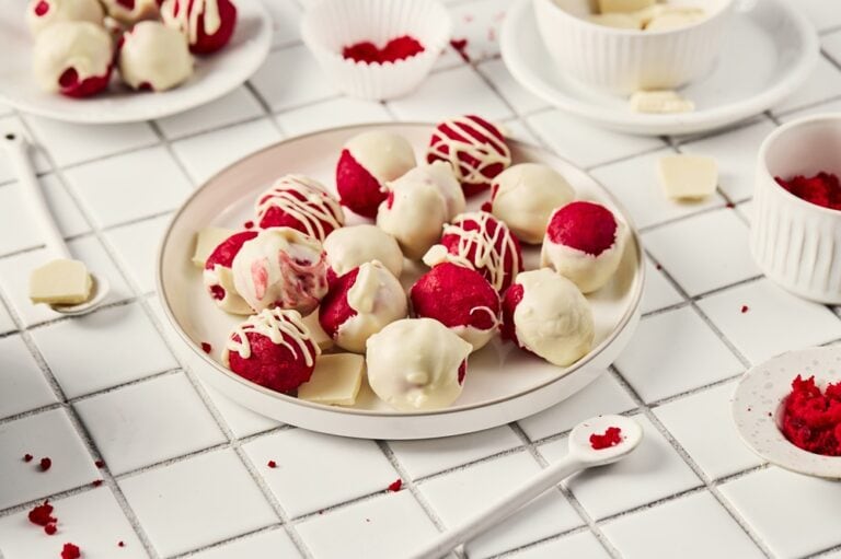 A picture of a plate of red velvet truffles.