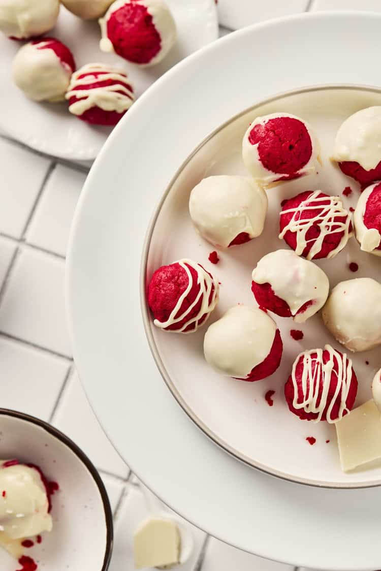 A picture of a plate of red velvet truffles.