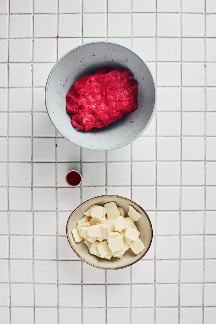 A picture of a bowl of red velvet dough.