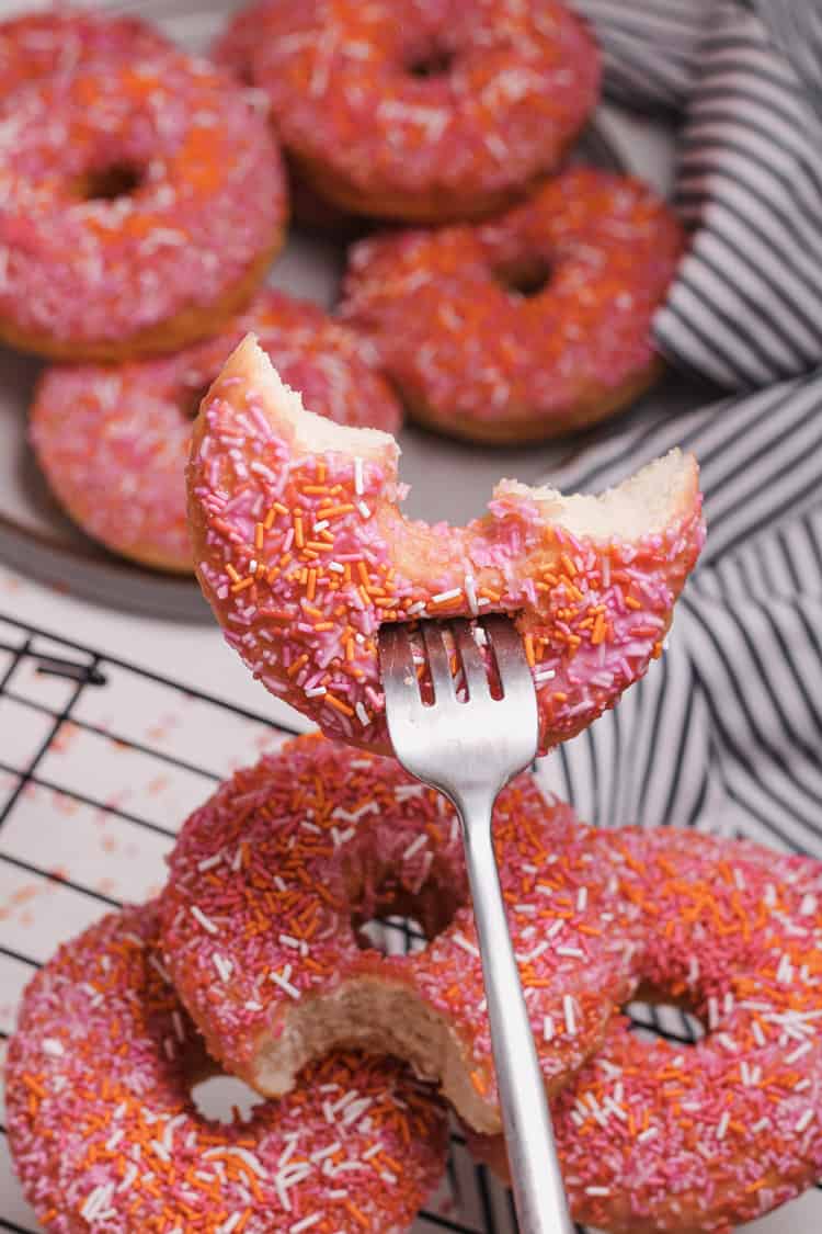 A picture of a half-eaten donut on a fork.
