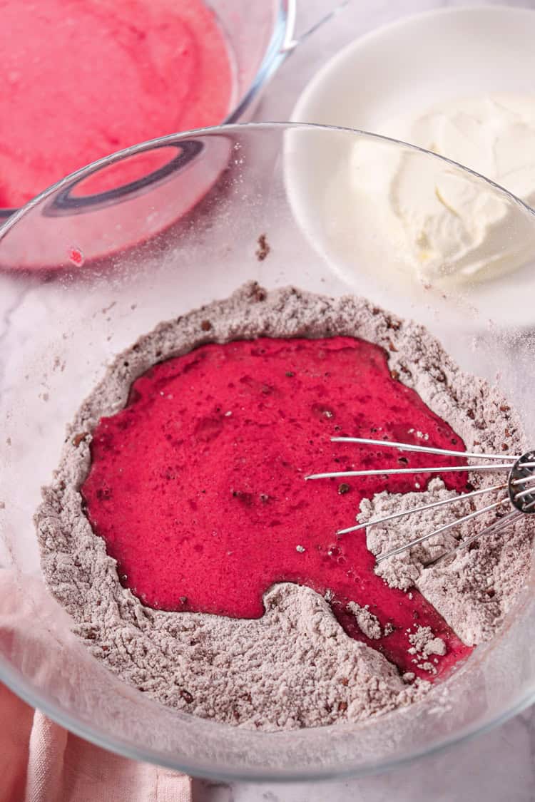 A picture of wet and dry ingredients in a bowl, unmixed.