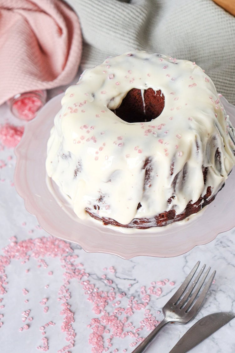 A picture of a fully baked and frosted bundt cake.