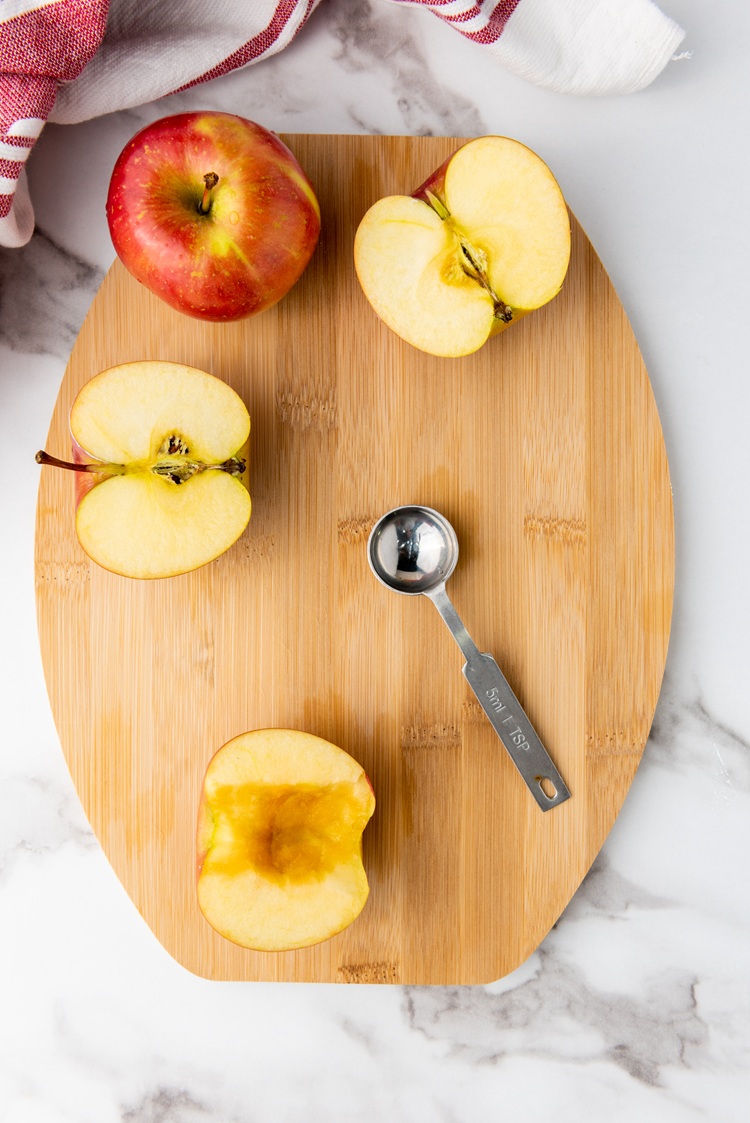 A picture of apples cut in half with the core removed.