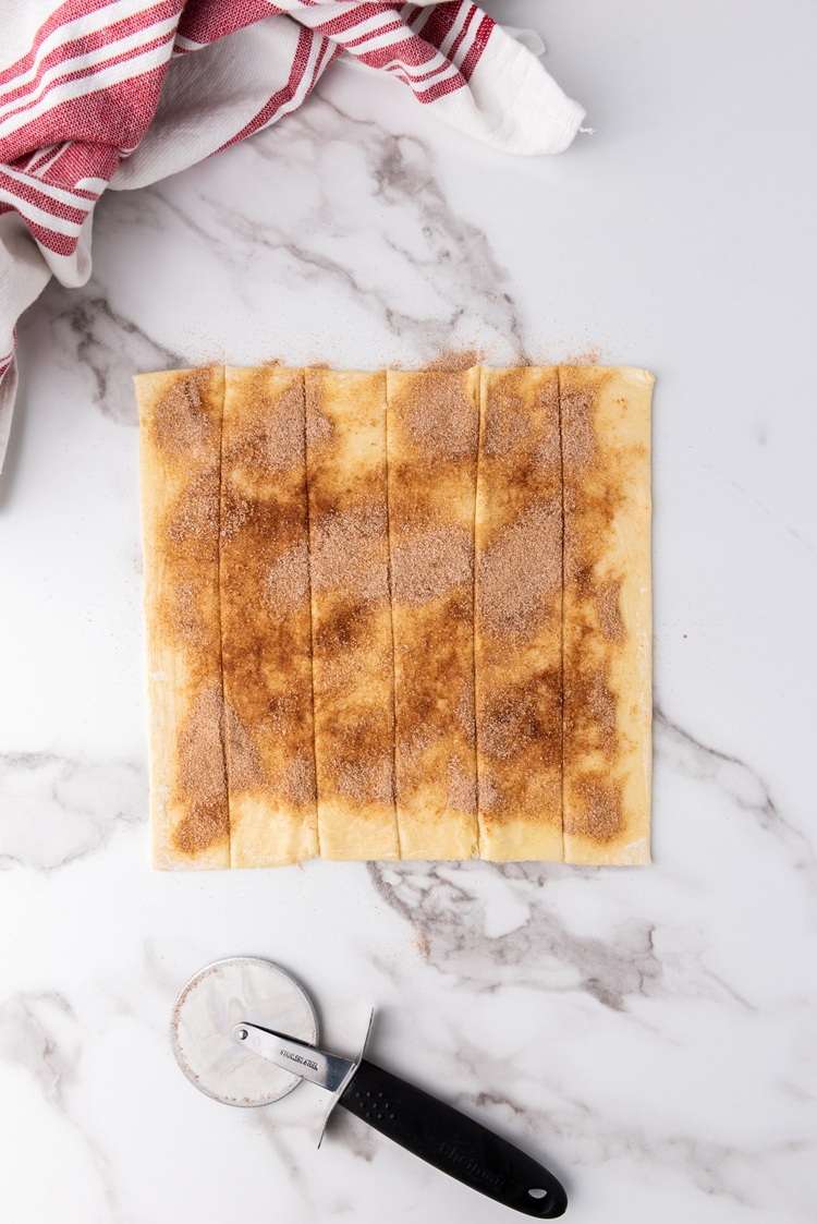 A picture of puff pastry sheets cut into strips.