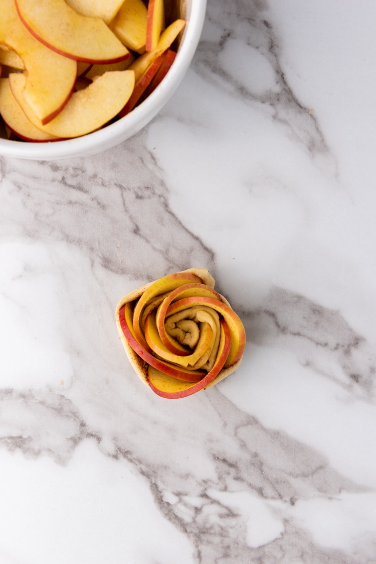A picture of a puff pastry rolled into the shape of a rose.