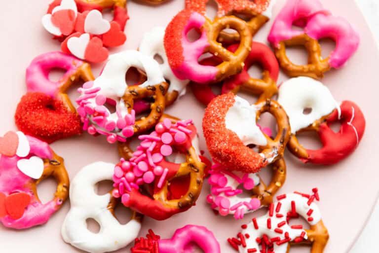 valentines day pretzels - pink red and white chocolate dipped pretzels on a white surface