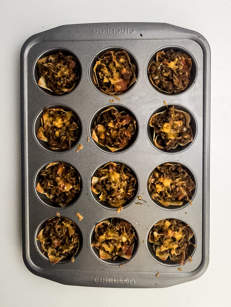 A picture of baked mini taco cups in cupcake tins.