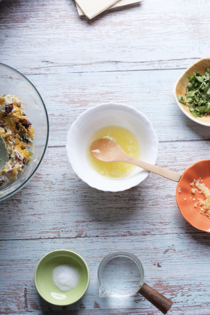 A picture of melted butter in a bowl with a spoon.