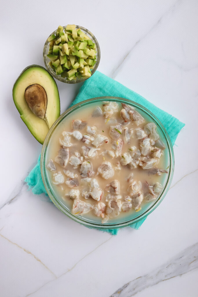 A picture of chopped shrimp denaturated in lemon and lime juice.