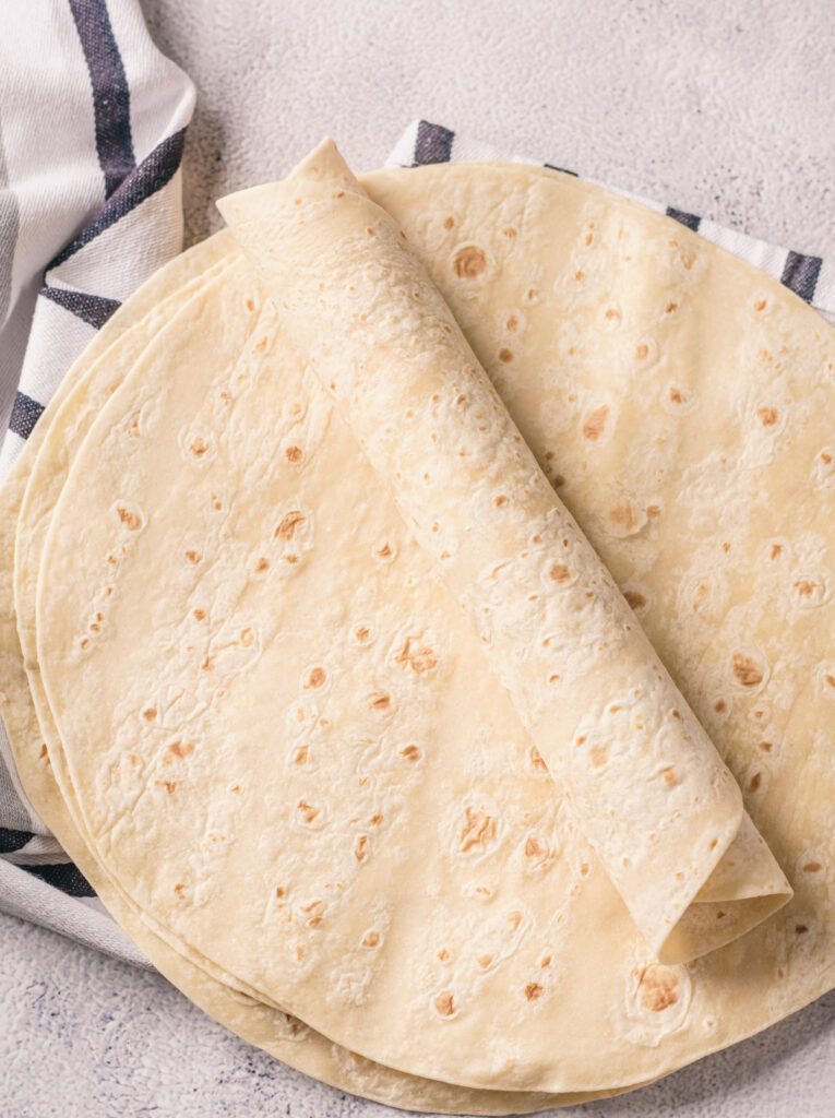 A picture of a flour tortilla rolled into a log shape.