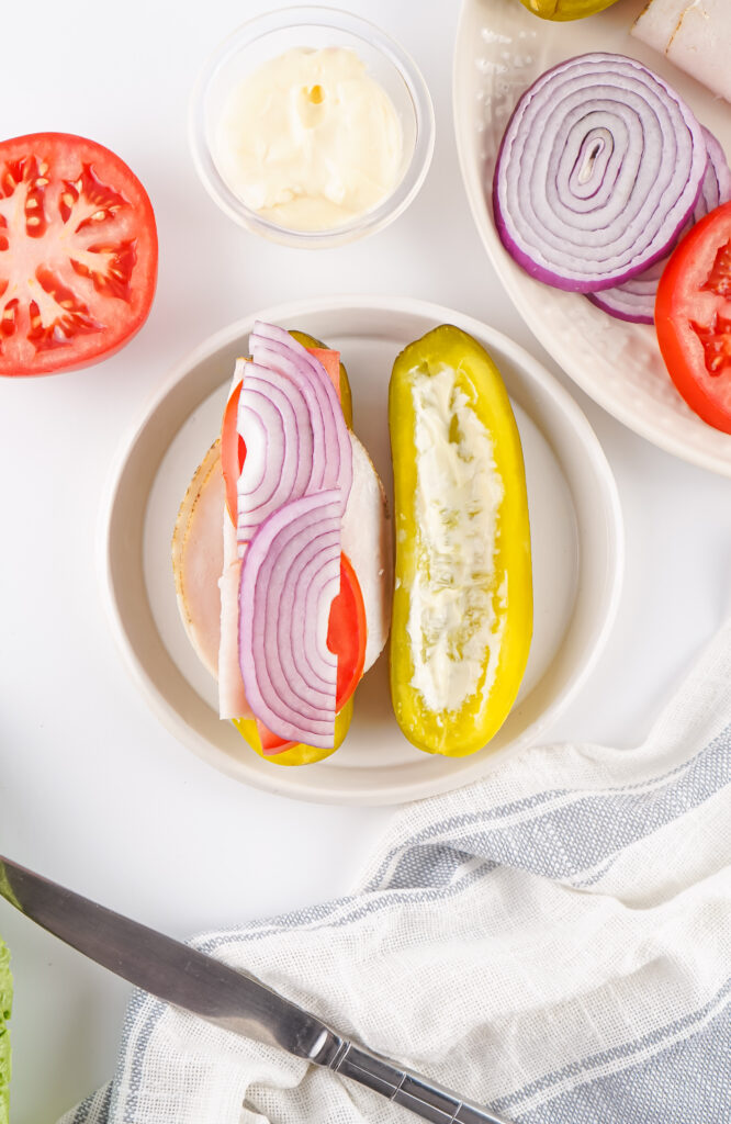 Add the tomato and onion slices (cut them in half first!).