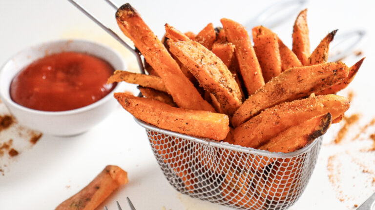 A picture of air fried sweet potatoes in a wire basket.