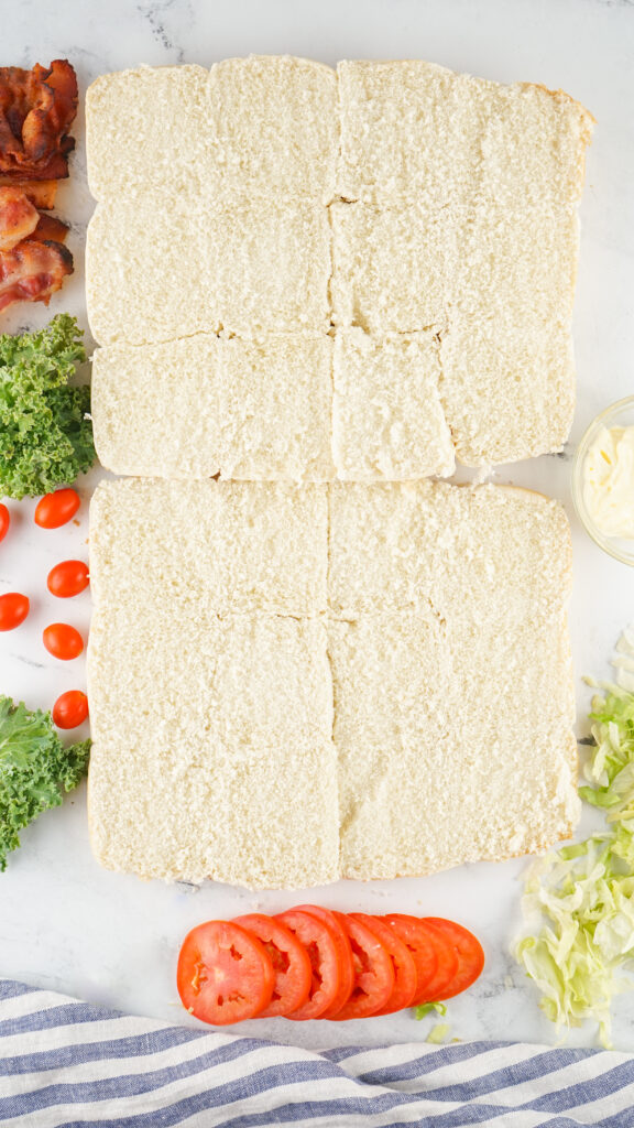 A picture of the top and bottom halves of sliced slider buns still connected on the sides.