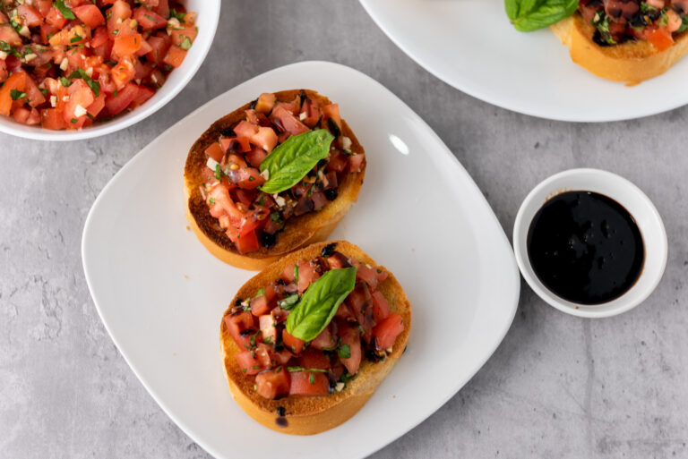A picture of two pieces of bruschetta on a white plate.