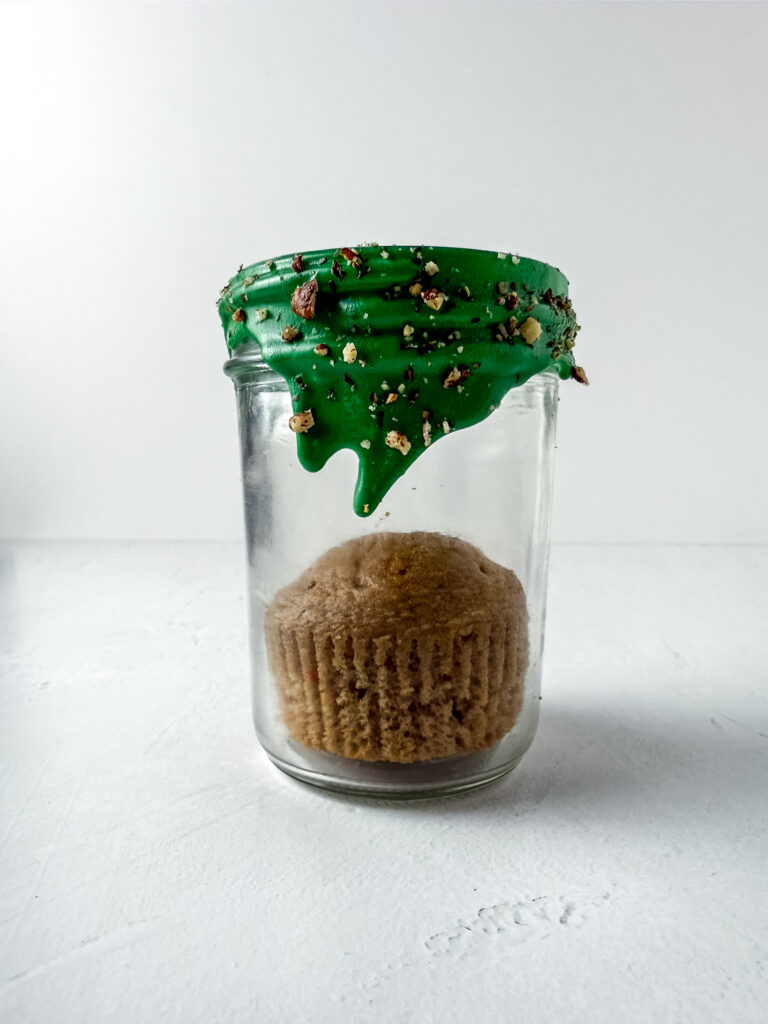 A picture of a carrot cake muffin in a jar.