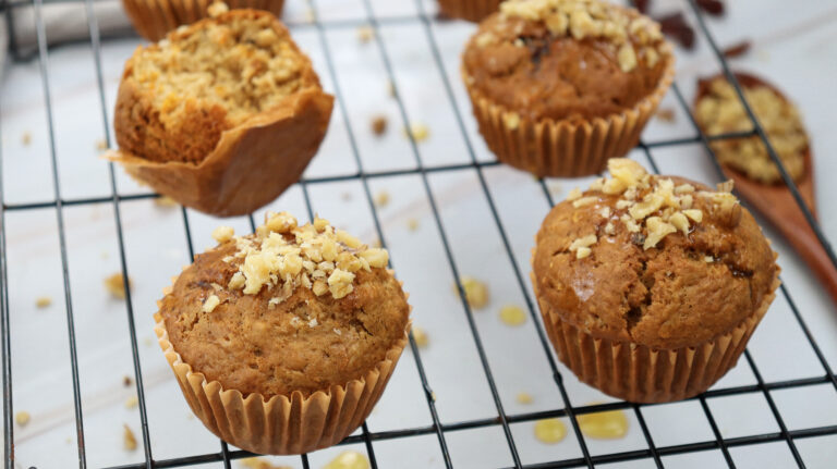 A picture of four carrot cake muffins.