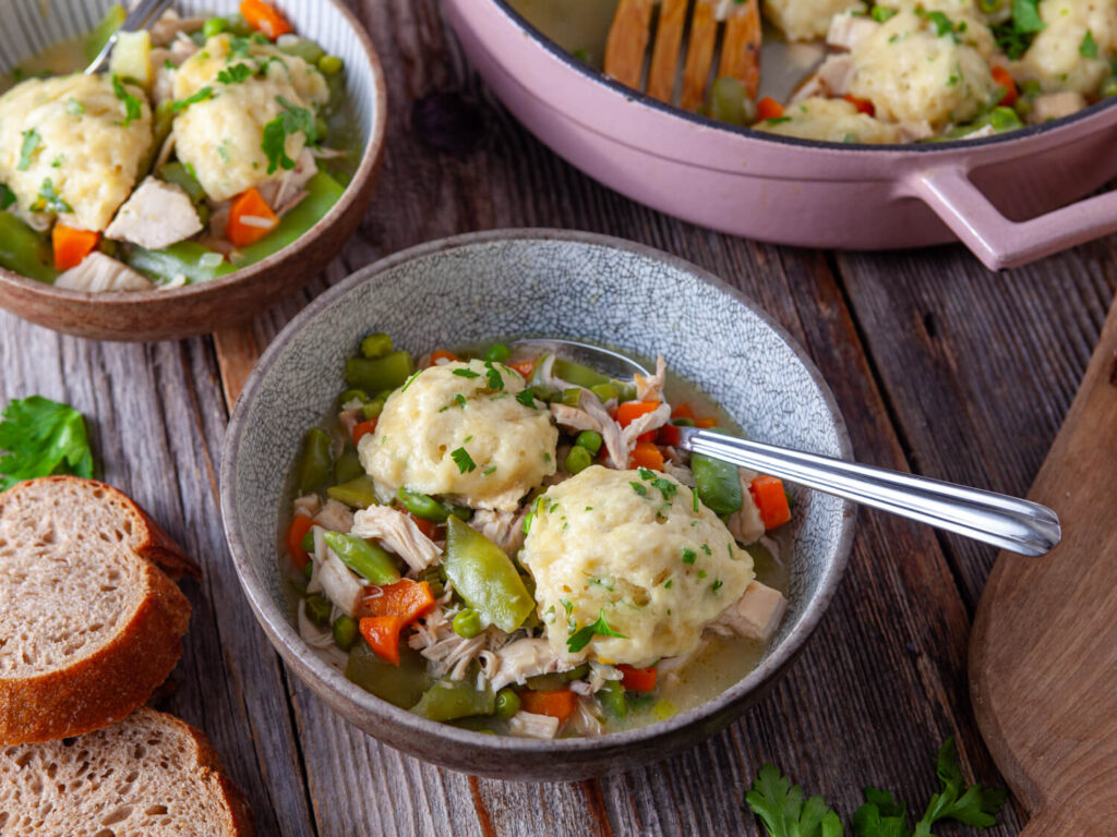 A picture of a bowl of chicken dumplings.