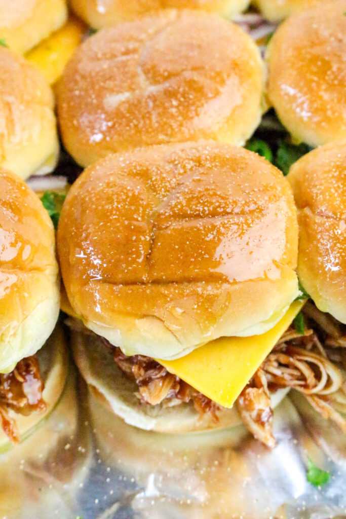A picture of a chicken slider brushed over the top with butter and garlic powder.