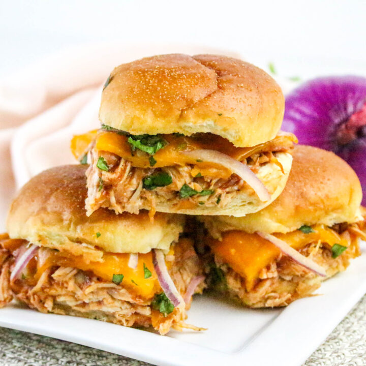 A picture of three chicken sliders with one slider stacked on top of the other two.