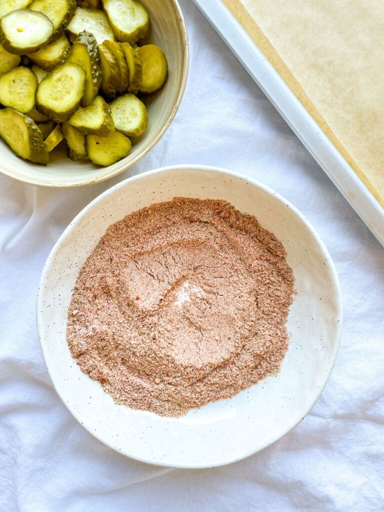 A picture of breadcrumbs, cornstarch, smoked paprika, dill, and garlic powder mixed together in a bowl.