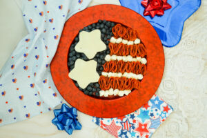 A picture of meats, cheeses, anf fruit arranged to resemble an American flag.